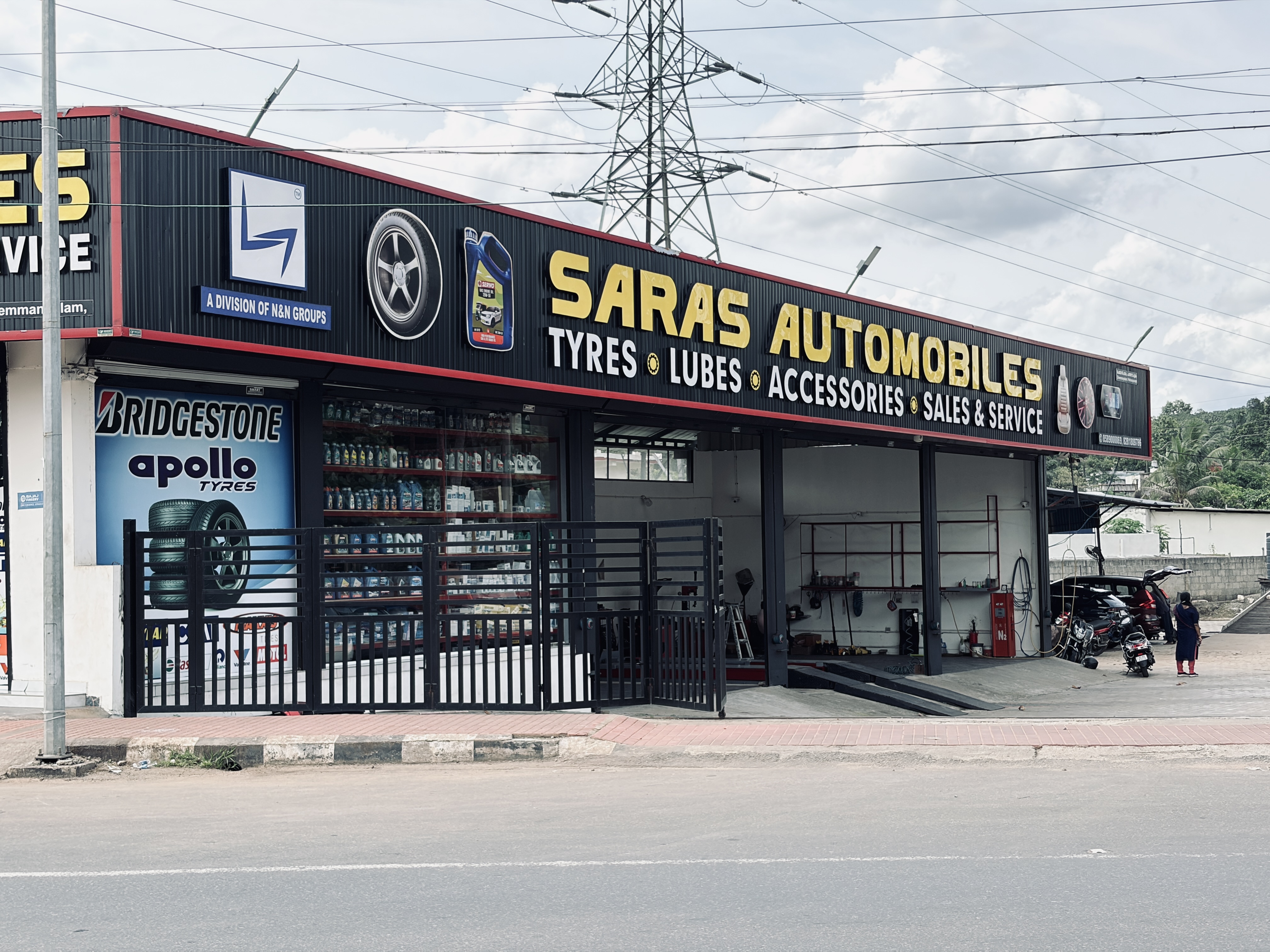 Mechanic inspecting car components at SARAS Automobiles